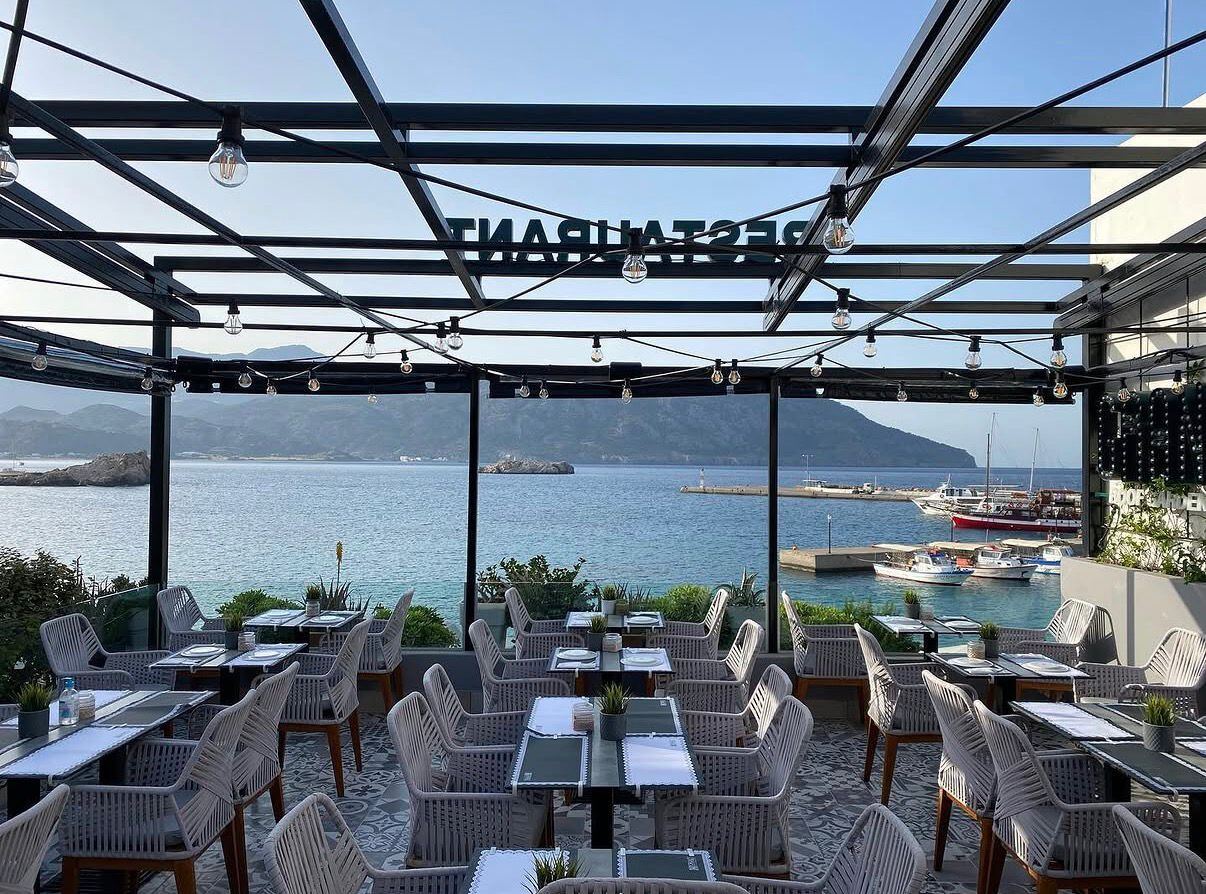 Panoramic view of Pigadia harbour at golden hour from Grande rooftop restaurant, Karpathos